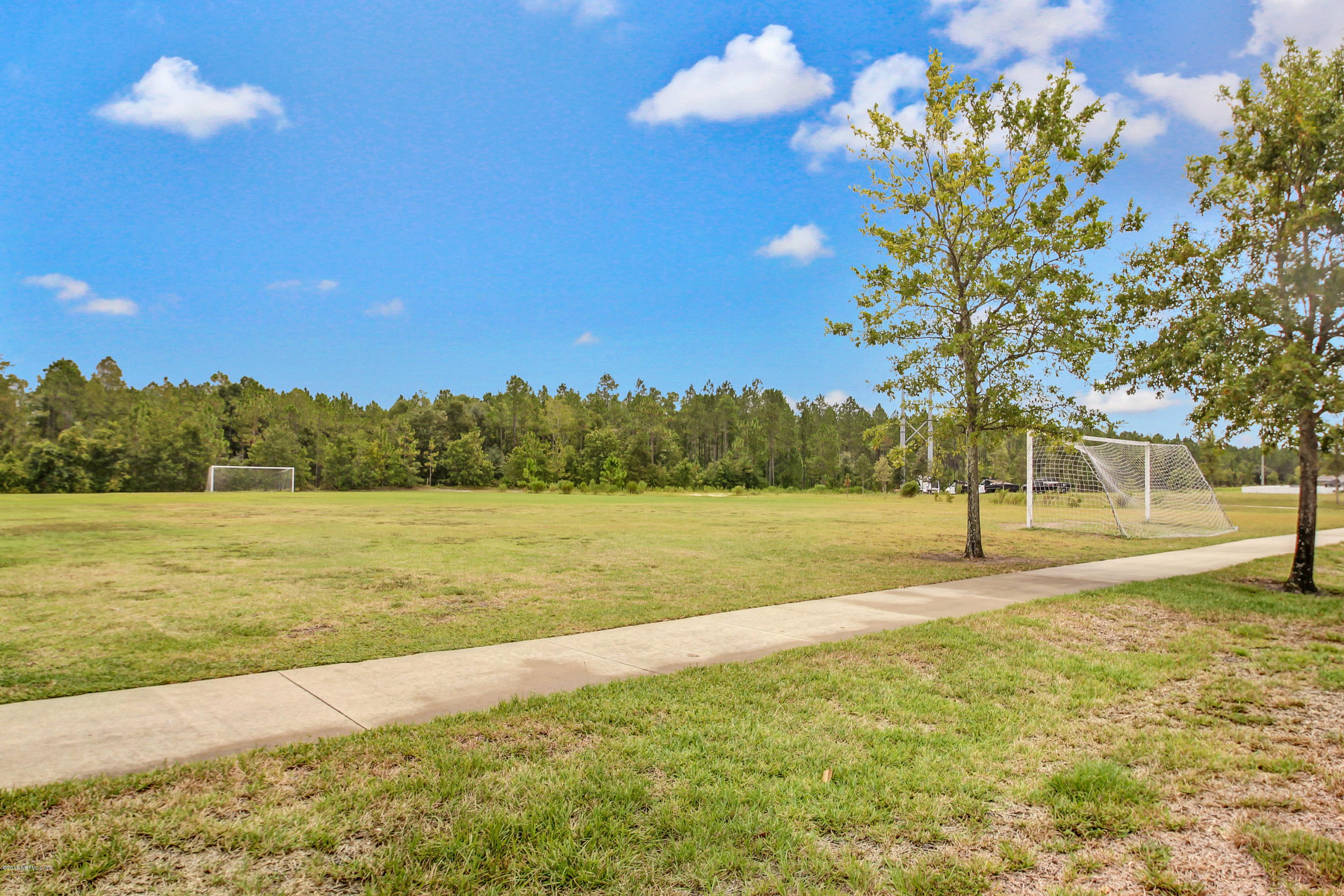 16480 Tisons Bluff Road Jacksonville, FL 32218 - Photo 76 of 80 a view of a lake with a yard and trees