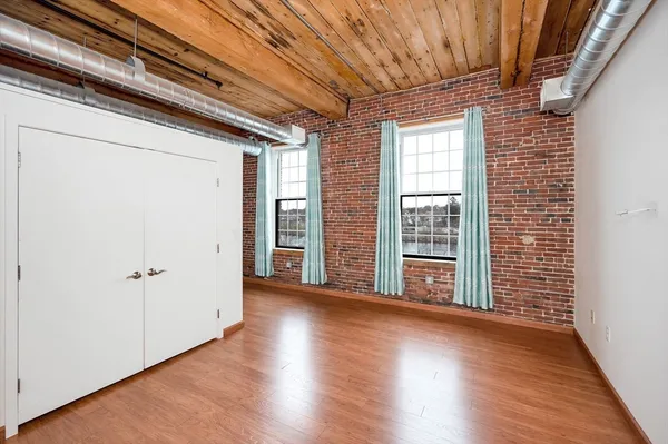 a view of room with wooden floor
