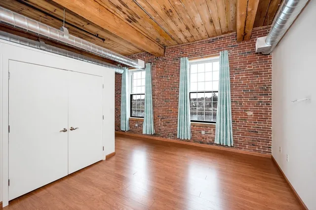 a view of room with wooden floor