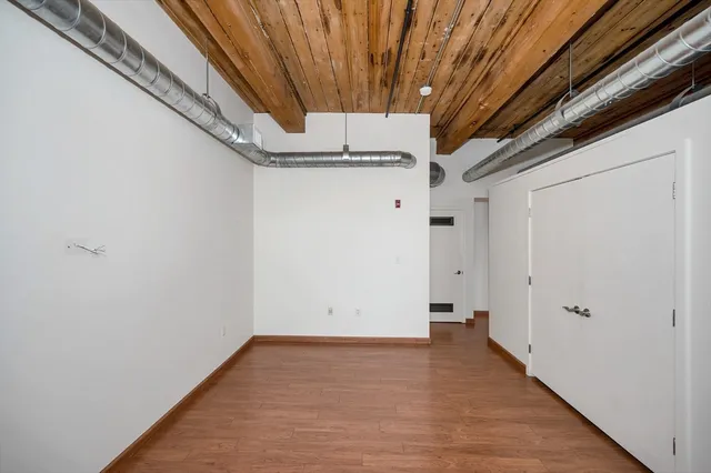 a view of a room with wooden floor