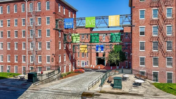 a view of a brick building with many windows