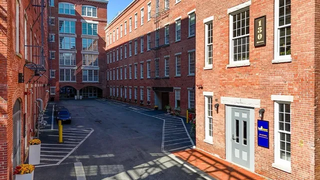 a front view of a brick building with large windows
