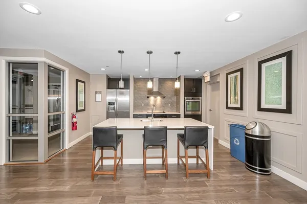 a dining room with furniture and a floor to ceiling window
