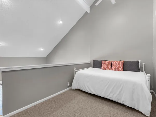 a bedroom with a bed and a night stand