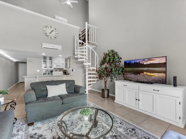 a living room with furniture and a potted plant