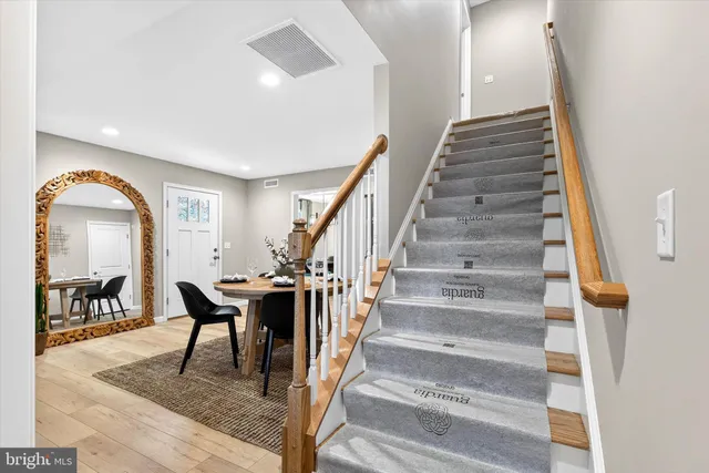 a view of entryway and hall with wooden floor