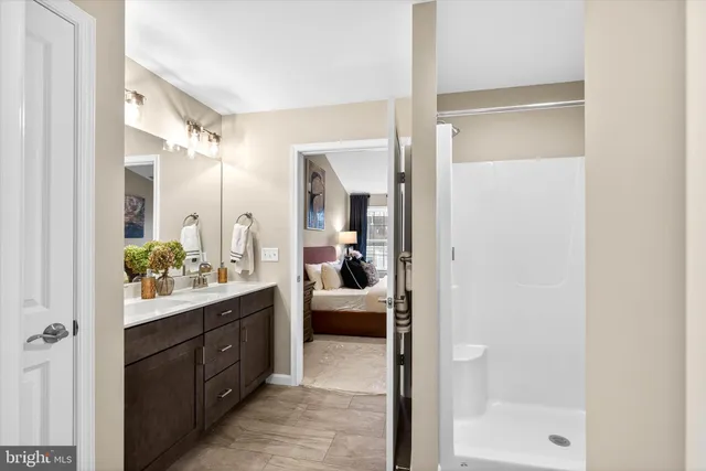 a en suite bathroom with a sink mirror and a bathtub