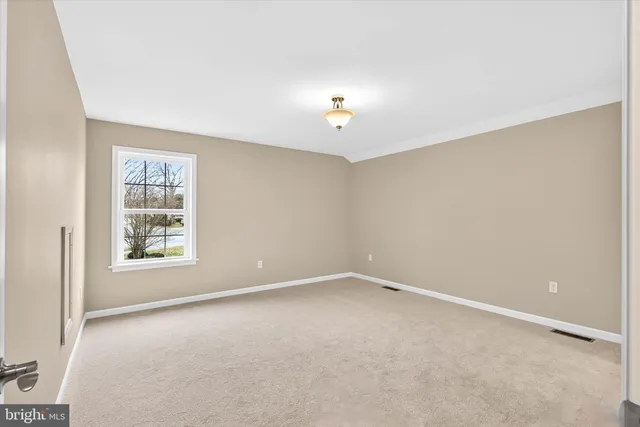 a view of an empty room with a chandelier