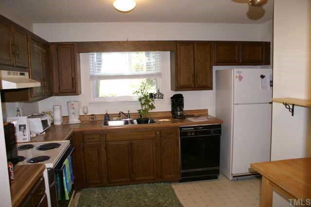 5454 Pine Top Circle Raleigh, NC 27612 - Photo 6 of 10 a kitchen with stainless steel appliances a stove sink refrigerator and a window