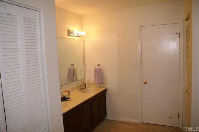 5454 Pine Top Circle Raleigh, NC 27612 - Photo 10 of 10 a bathroom with a granite countertop sink and a mirror