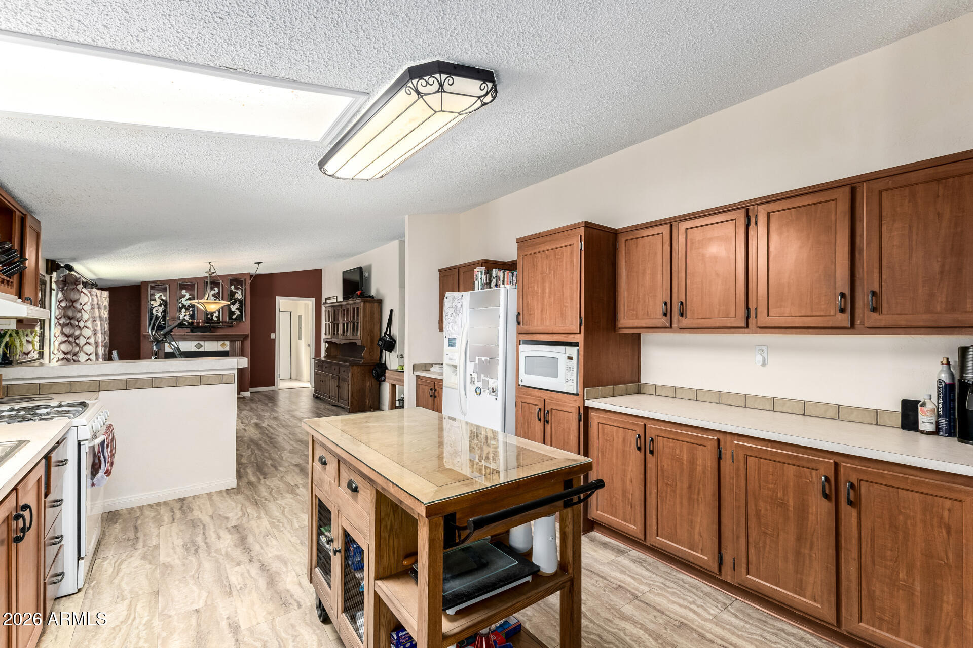 9987 North Geronimo Drive Casa Grande, AZ 85122 - Photo 14 of 53 a kitchen with cabinets wooden floor and stainless steel appliances
