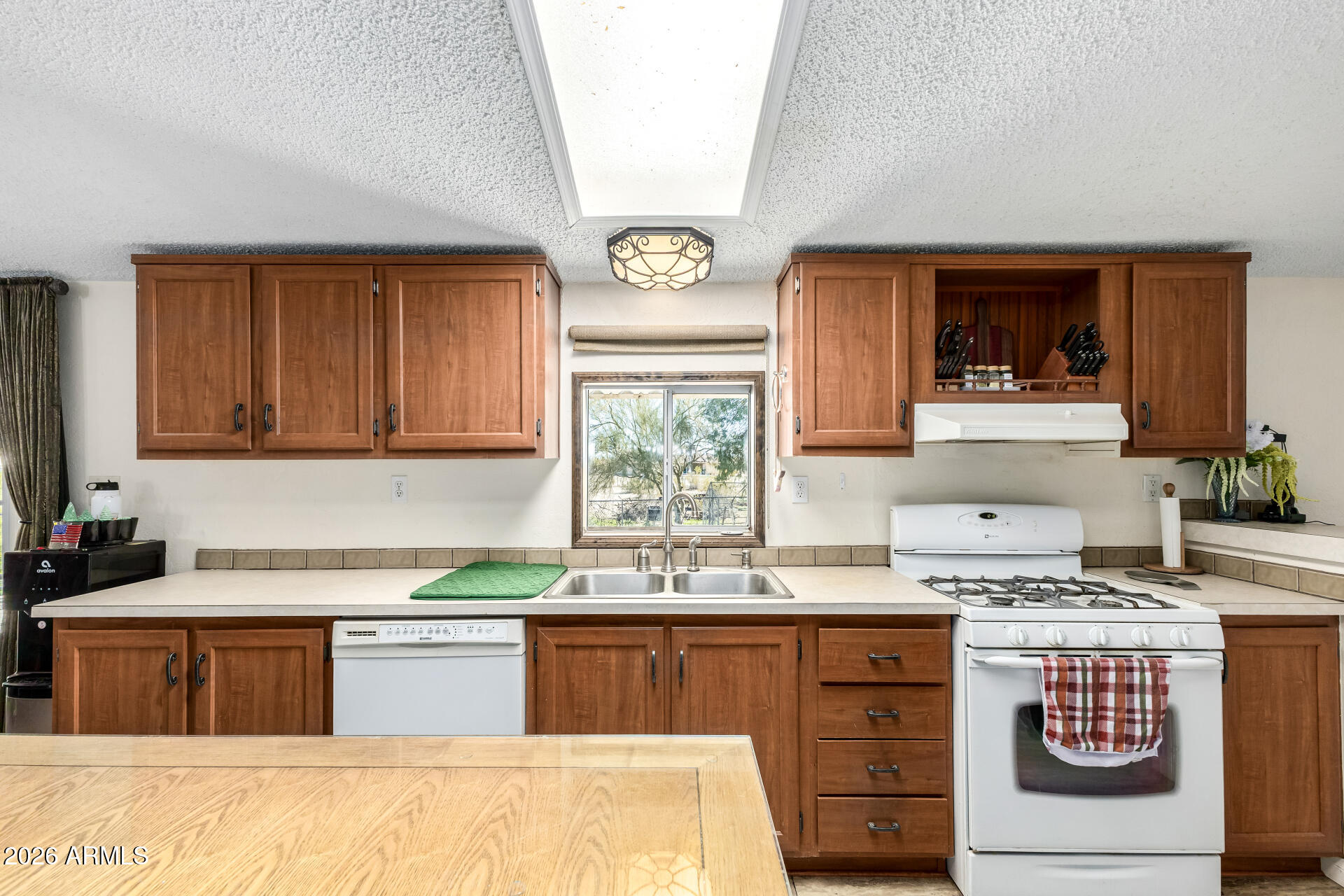 9987 North Geronimo Drive Casa Grande, AZ 85122 - Photo 15 of 53 a kitchen with stainless steel appliances granite countertop a stove a sink and a microwave
