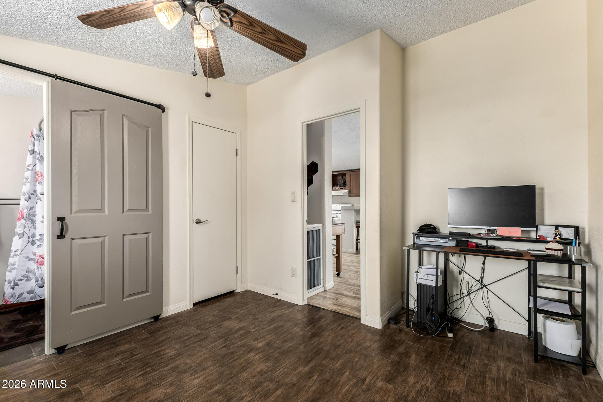 9987 North Geronimo Drive Casa Grande, AZ 85122 - Photo 28 of 53 a view of a livingroom with a flat screen tv wooden floor and a ceiling fan