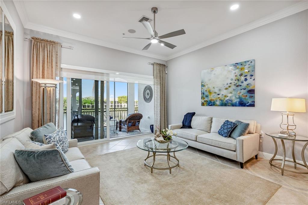 9259 Museo Circle, Unit 201 Naples, FL 34114 - Photo 11 of 50 a living room with furniture and a large window
