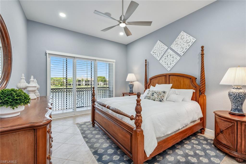 9259 Museo Circle, Unit 201 Naples, FL 34114 - Photo 13 of 50 a bed sitting in a spacious bedroom next to a window
