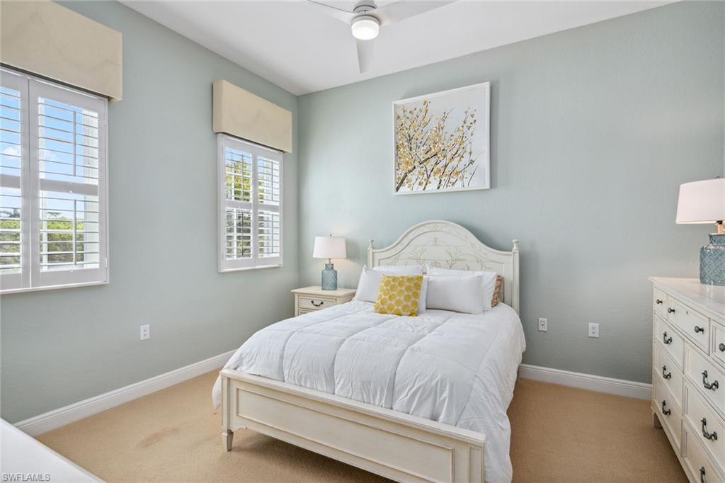 9259 Museo Circle, Unit 201 Naples, FL 34114 - Photo 17 of 50 a bedroom with a bed and a window