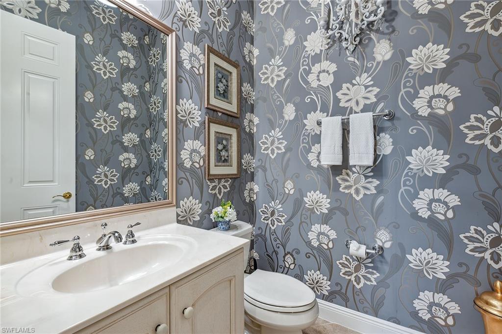 9259 Museo Circle, Unit 201 Naples, FL 34114 - Photo 22 of 50 a bathroom with a sink toilet and mirror