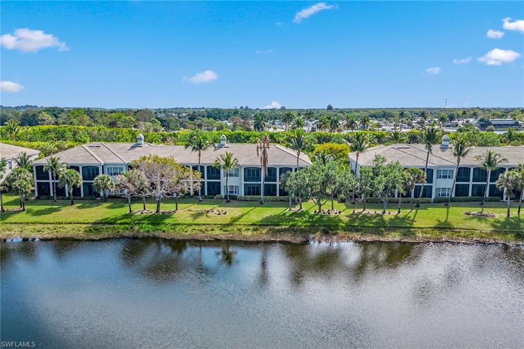 9259 Museo Circle, Unit 201 Naples, FL 34114 - Photo 29 of 50 a view of residential houses with outdoor space and lake view