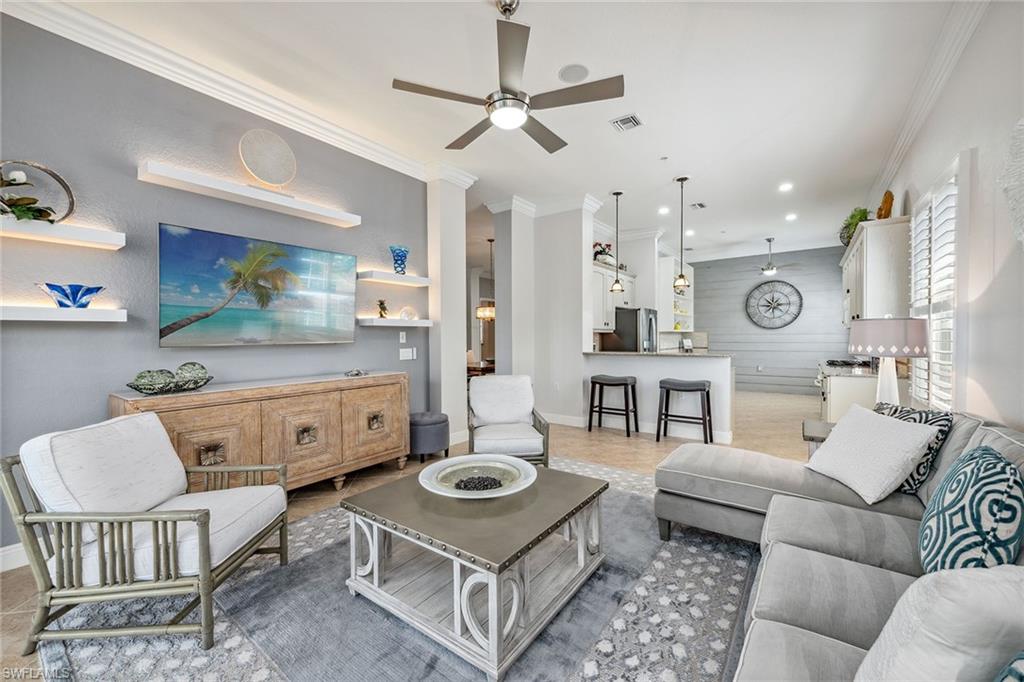 9259 Museo Circle, Unit 201 Naples, FL 34114 - Photo 3 of 50 a living room with furniture and a table