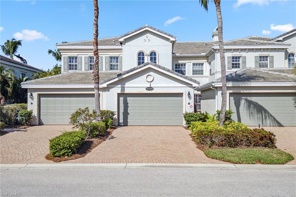 9259 Museo Circle, Unit 201 Naples, FL 34114 - Photo 32 of 50 a front view of a house with a garden