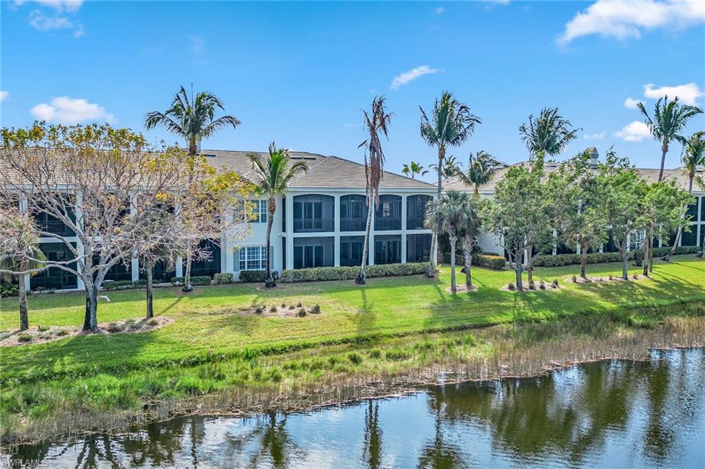 9259 Museo Circle, Unit 201 Naples, FL 34114 - Photo 47 of 50 a view of a swimming pool with a yard and plants