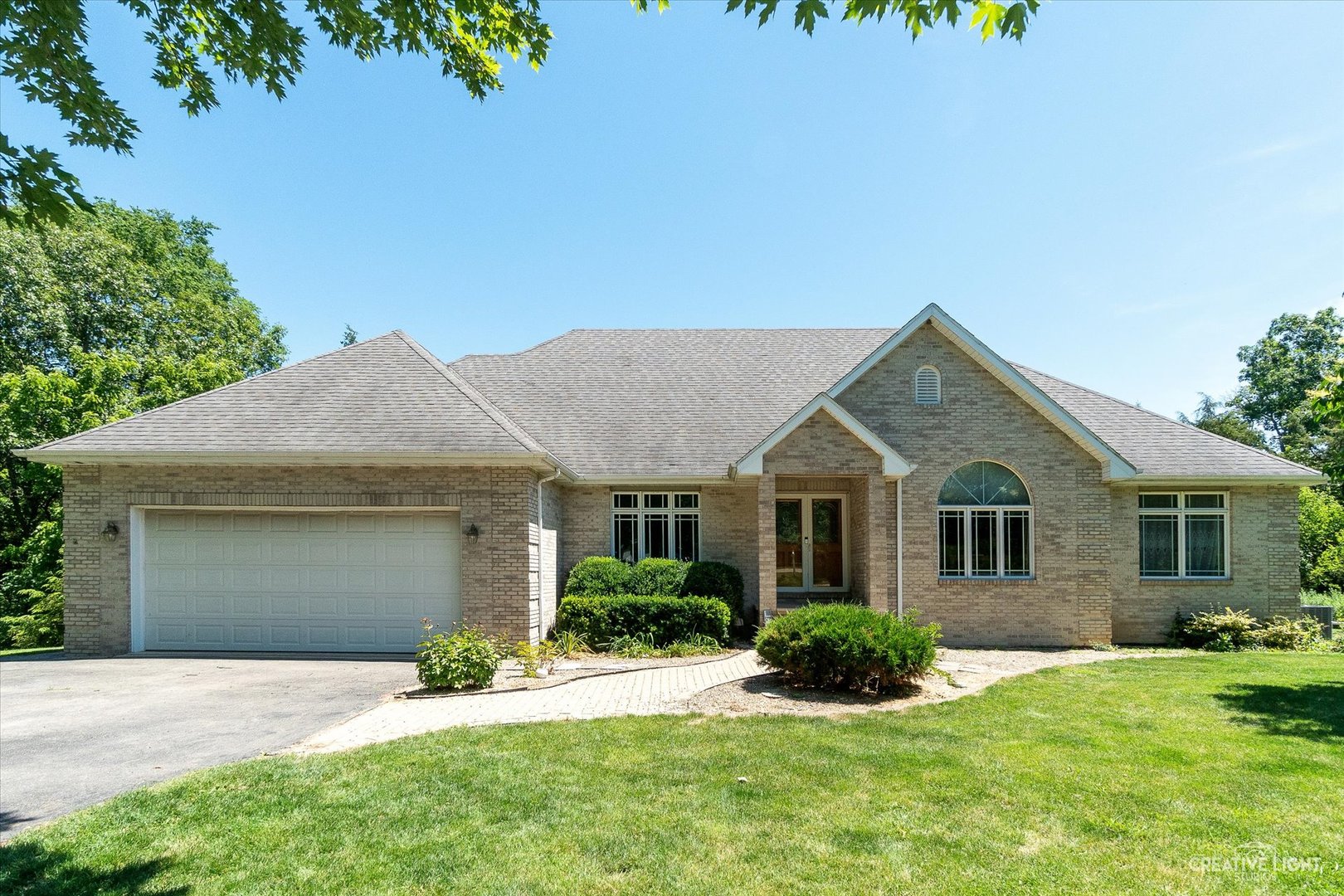 a front view of a house with a yard and garage