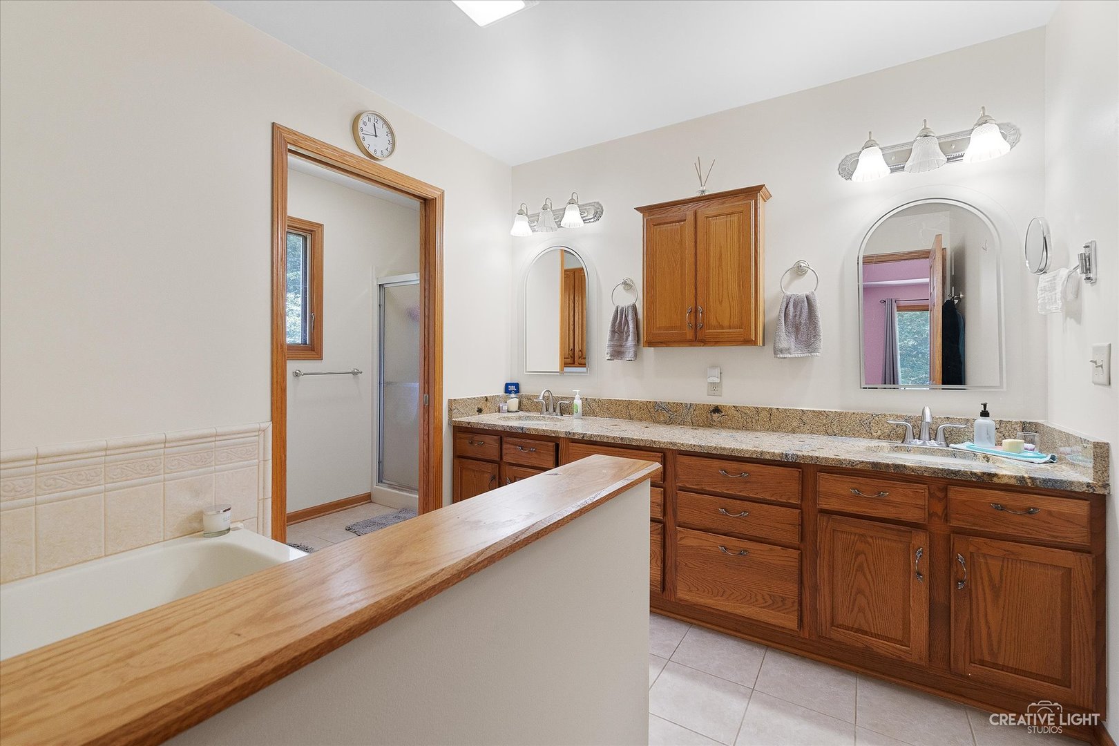 3684 East 2619 Th Road Sheridan, IL 60551 - Photo 15 of 32 a bathroom with a tub a double vanity sink and mirror