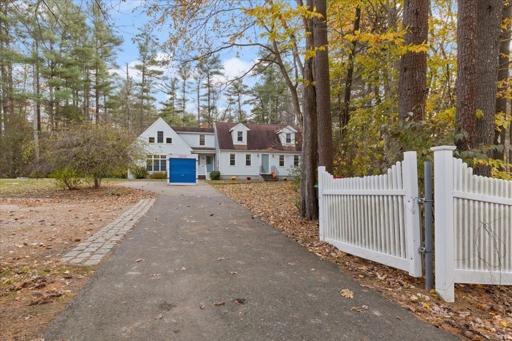 294 County Road Hanson, MA 02341 - Photo 4 of 38 a view of a large house with a large tree and wooden fence