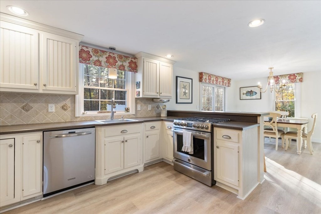 294 County Road Hanson, MA 02341 - Photo 8 of 38 a kitchen with granite countertop white cabinets and white appliances