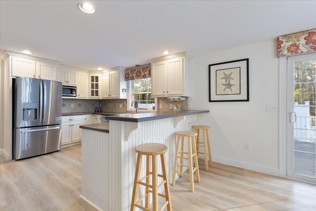 294 County Road Hanson, MA 02341 - Photo 10 of 38 a kitchen with stainless steel appliances granite countertop a refrigerator and a stove top oven