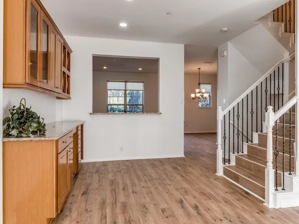 a view of hallway with wooden floor and stairs
