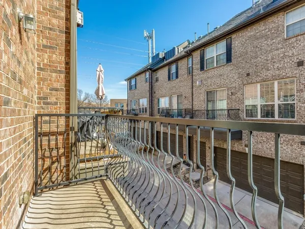 a view of a balcony with wooden floor and fence