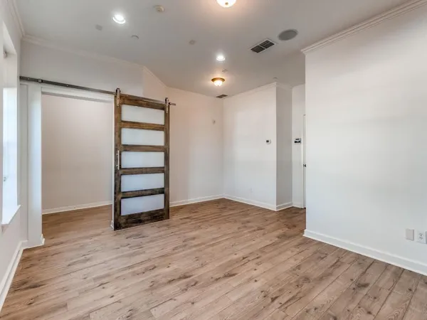 a view of wooden floor and windows in a room