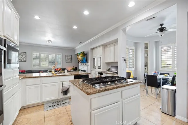 a kitchen with stainless steel appliances granite countertop a refrigerator and a stove top oven