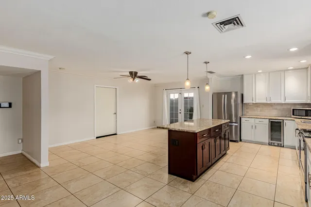 a kitchen with stainless steel appliances granite countertop a stove and a refrigerator