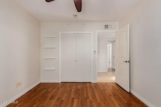 a view of a room with wooden floor and white walls