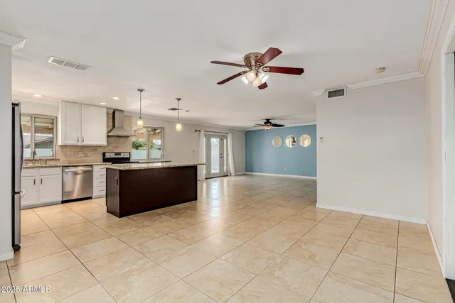 a view of kitchen with refrigerator and cabinets