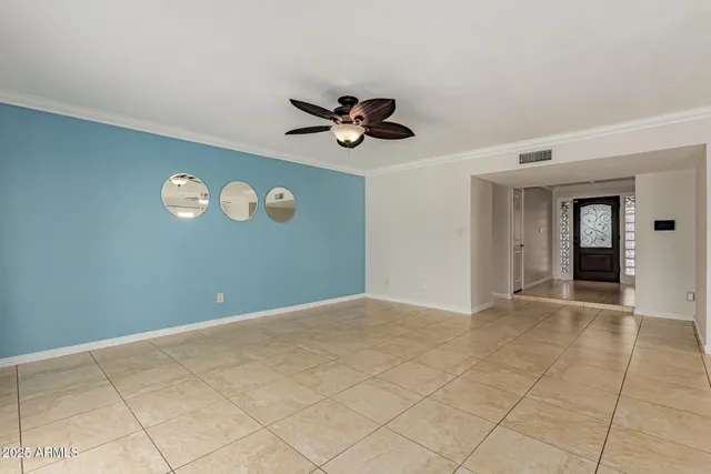 a view of an empty room with a ceiling fan