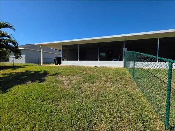 a view of a house with a yard and porch