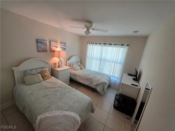 a bedroom with two beds and a window