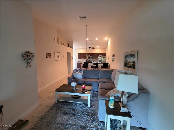 a living room with furniture and a chandelier