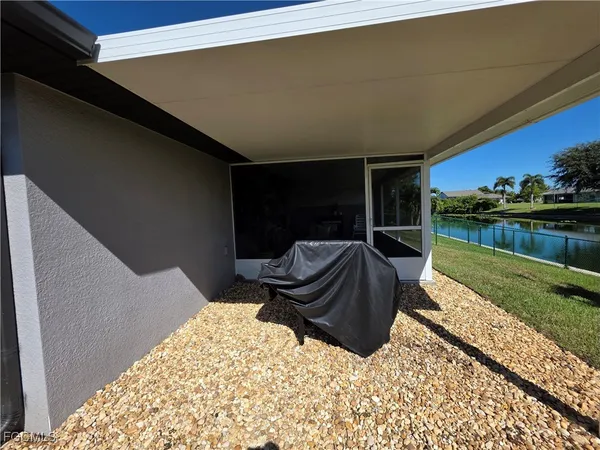 a backyard of a house with table and chairs