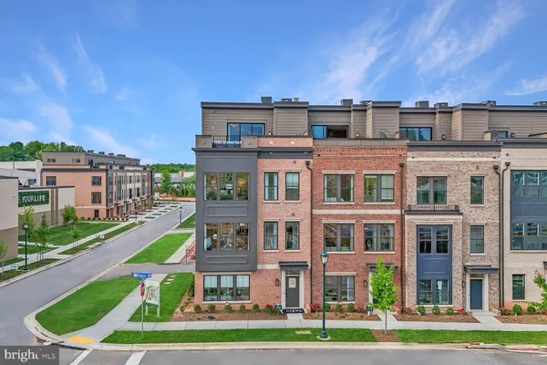 a front view of a building with a yard