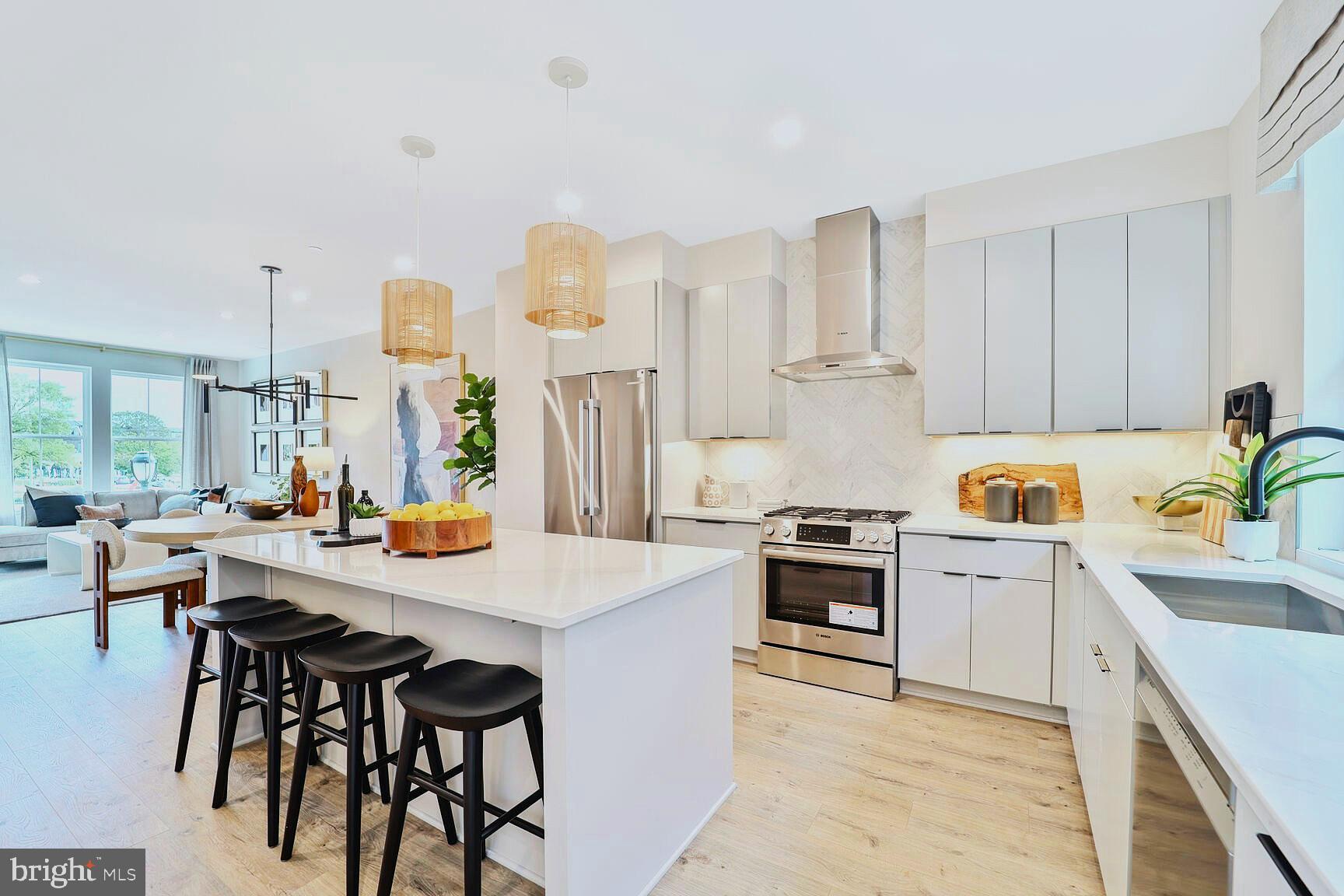 1135 Polaris Road, Unit CAMBRIDGE 78 Potomac, MD 20854 - Photo 3 of 11 a kitchen with stainless steel appliances granite countertop a stove and white cabinets