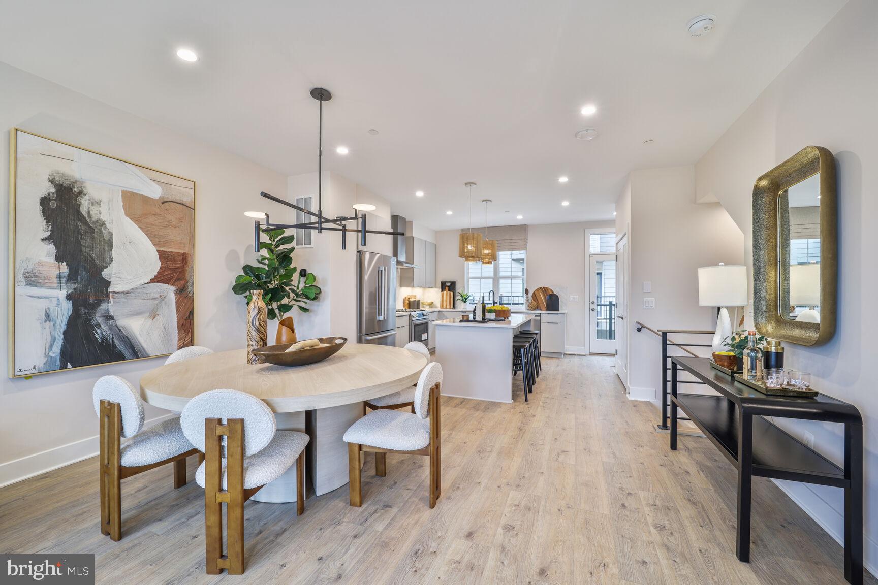 1135 Polaris Road, Unit CAMBRIDGE 78 Potomac, MD 20854 - Photo 6 of 11 a dining room with furniture a chandelier and wooden floor
