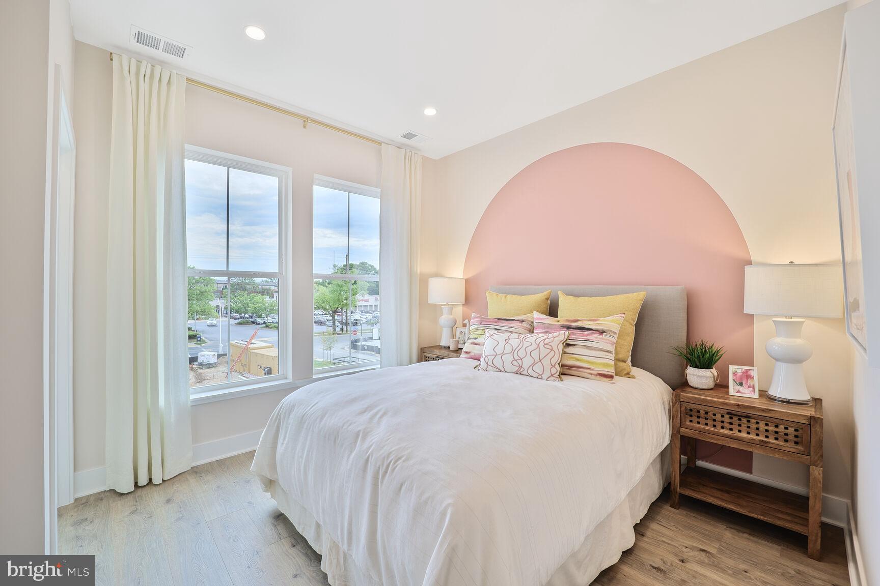 1135 Polaris Road, Unit CAMBRIDGE 78 Potomac, MD 20854 - Photo 9 of 11 a bedroom with a bed and a large window