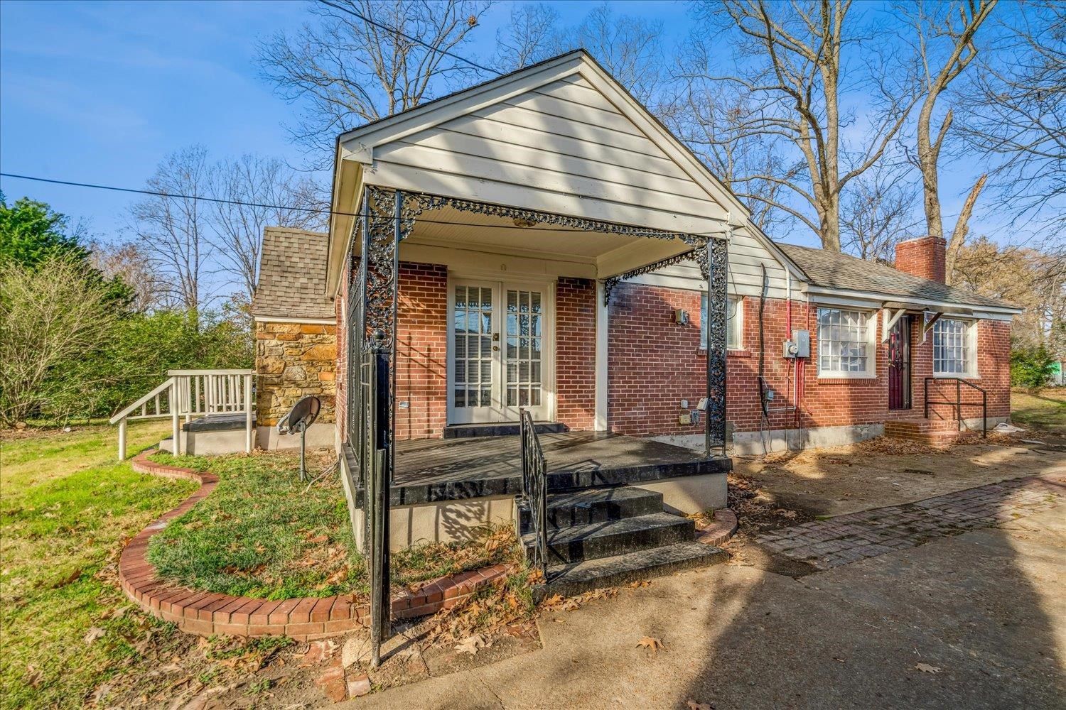 1114 Brownlee Road Memphis, TN 38116 - Photo 28 of 32 View of front facade with a shingled roof, a chimney, brick siding, and french doors