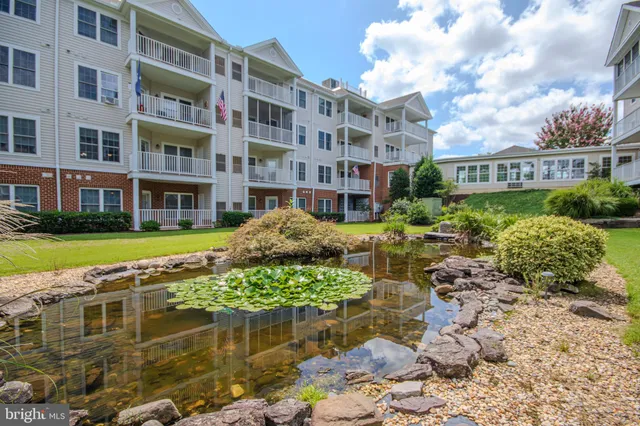a dining room with furniture a chandelier and a projector screen
