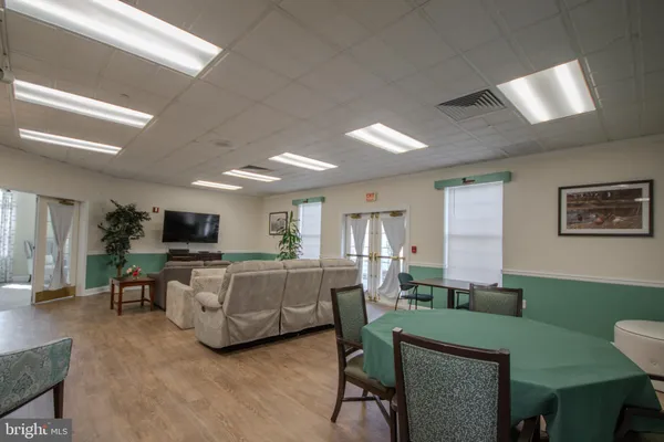 a view of a dining room with furniture and a bookshelf