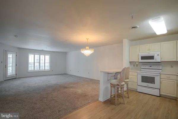 a kitchen with a refrigerator a stove a microwave and cabinets